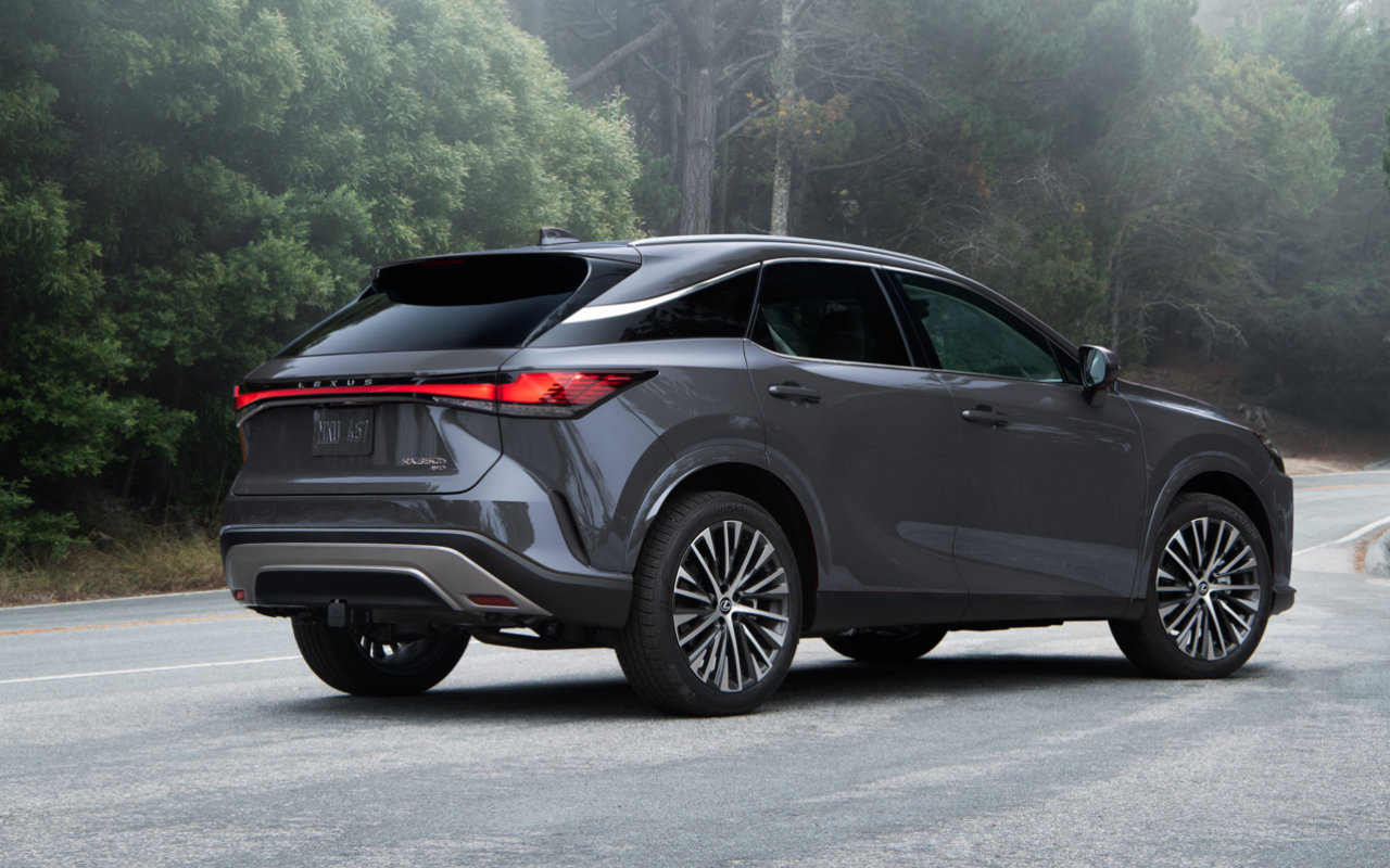 Rear 3/4 view of the 2023 Lexus RX SUV parked on a road.