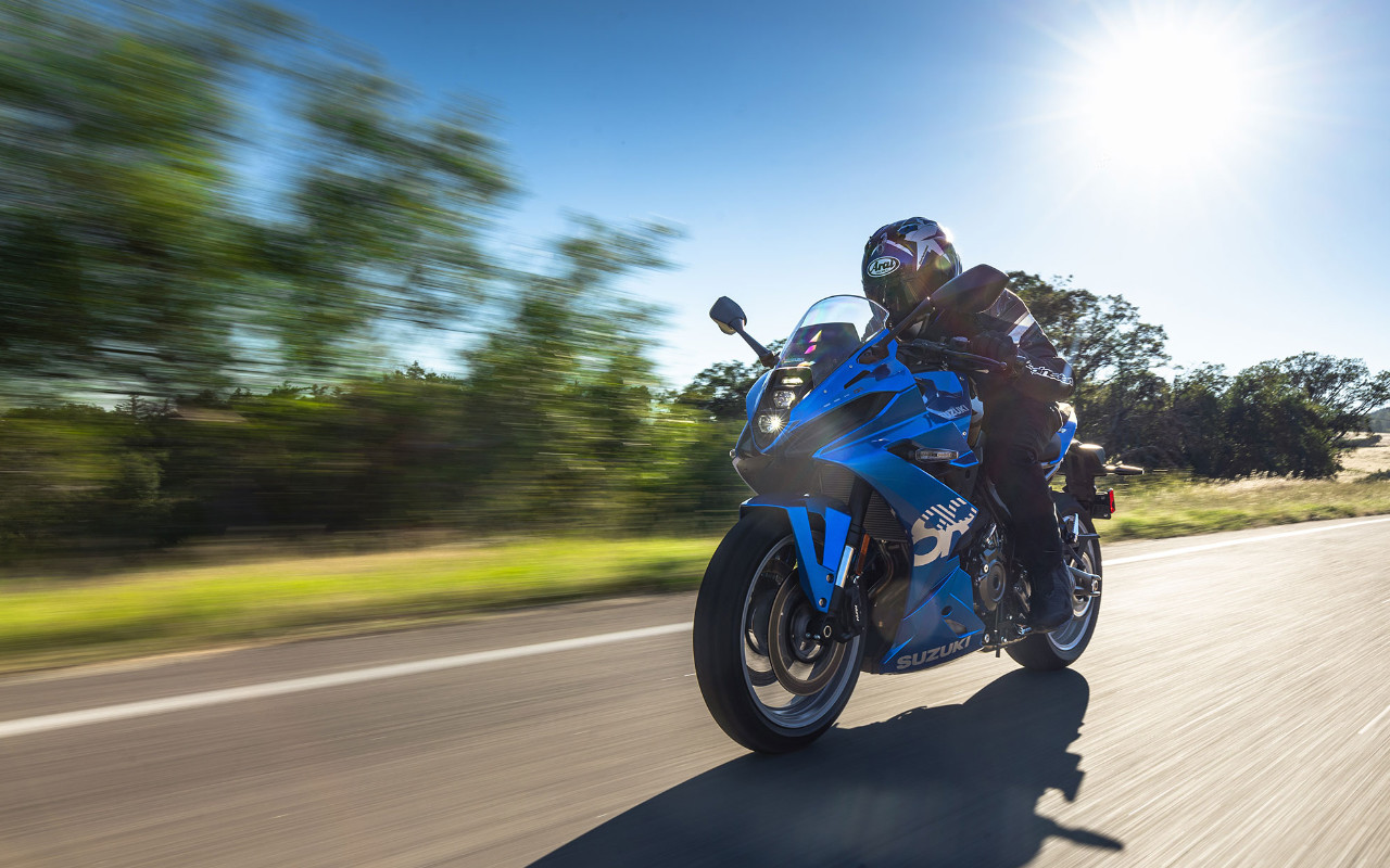front side view of a 2024 Suzuki GSX-8R and its driver on a country road