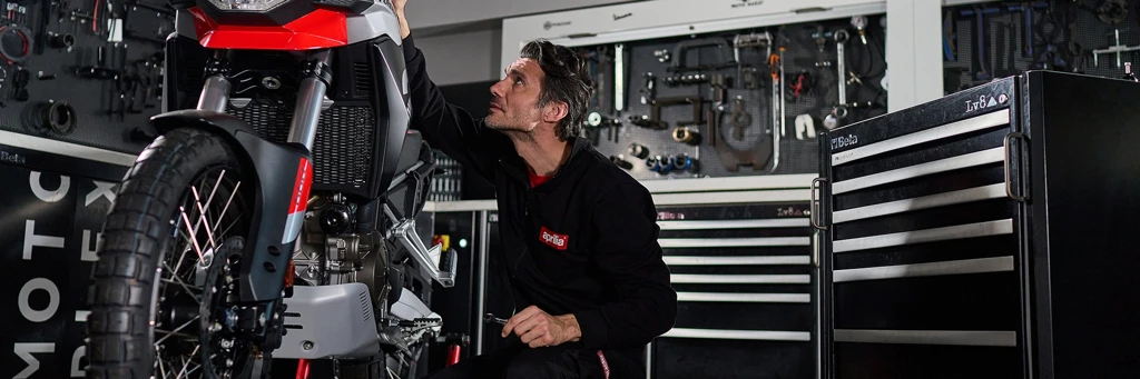 Mechanic repairing a motorcycle in the maintenance and repair department.