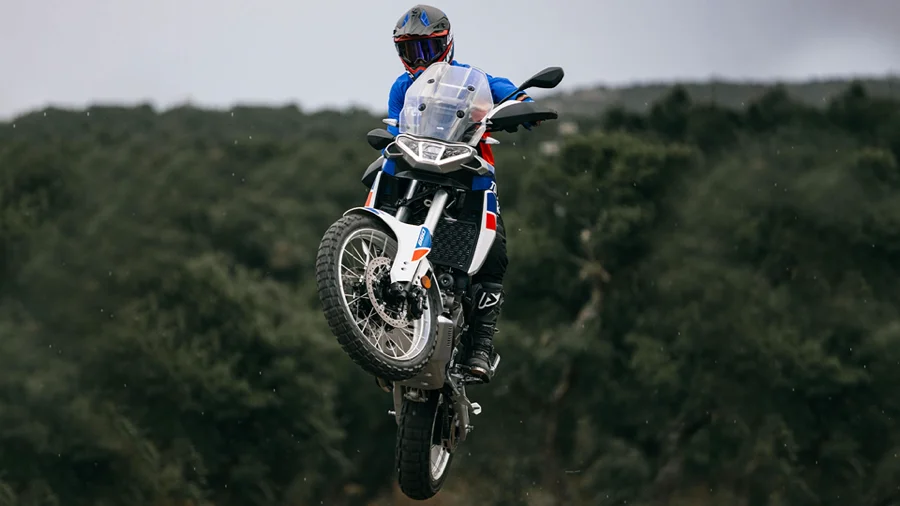 Motorcyclist in the air with an Aprilia motorcycle.